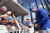 Toronto Blue Jays starting pitcher Jose Berrios, right, signs autographs for fans during baseball spring training in Dunedin, Fla., on Sunday, February 19, 2023. A recent survey of fans voted Blue Jays supporters the fifth least annoying and 11th best-behaved in all of MLB. THE CANADIAN PRESS/Nathan Denette