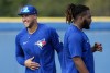 Toronto Blue Jays centre fielder George Springer, left, laughs next to Toronto Blue Jays first baseman Vladimir Guerrero Jr. during baseball spring training in Dunedin, Fla., Thursday, Feb. 23, 2023. Springer hit a two-run homer as a Toronto Blue Jays split squad beat the Atlanta Braves 3-1 in spring training baseball action Thursday.THE CANADIAN PRESS/Nathan Denette