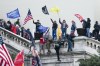 FILE - Rioters wave flags on the West Front of the U.S. Capitol in Washington on Jan. 6, 2021. Federal prosecutors are employing an unusual strategy to prove leaders of the far-right Proud Boys extremist group orchestrated a violent plot to keep President Joe Biden out of the White House, even though some of the defendants didn't carry out the violence themselves. AP Photo/Jose Luis Magana, File)