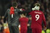 Liverpool's goalkeeper Alisson and Liverpool's Roberto Firmino celebrate after the the English Premier League soccer match between Liverpool and Manchester United at Anfield in Liverpool, England, Sunday, March 5, 2023. Liverpool won the match 7-0. (AP Photo/Jon Super)