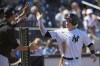 New York Yankees' Harrison Bader, right, celebrates after scoring on a wild pitch during the fourth inning of a spring training baseball game against the Washington Nationals Wednesday, March 1, 2023, in Tampa, Fla. (AP Photo/David J. Phillip)
