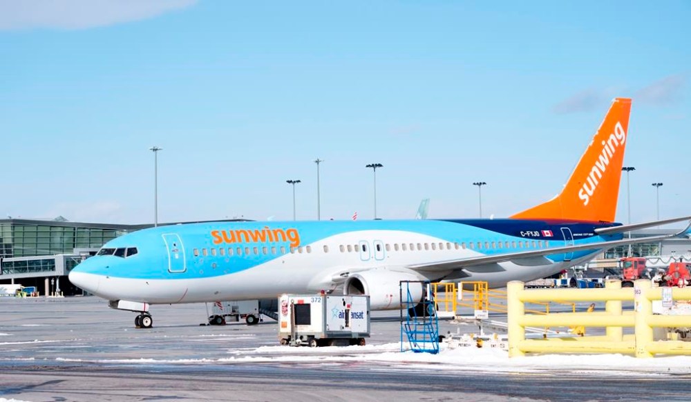A Sunwing aircraft is parked at Montreal Trudeau airport in Montreal on Wednesday, March 2, 2022. THE CANADIAN PRESS/Paul Chiasson