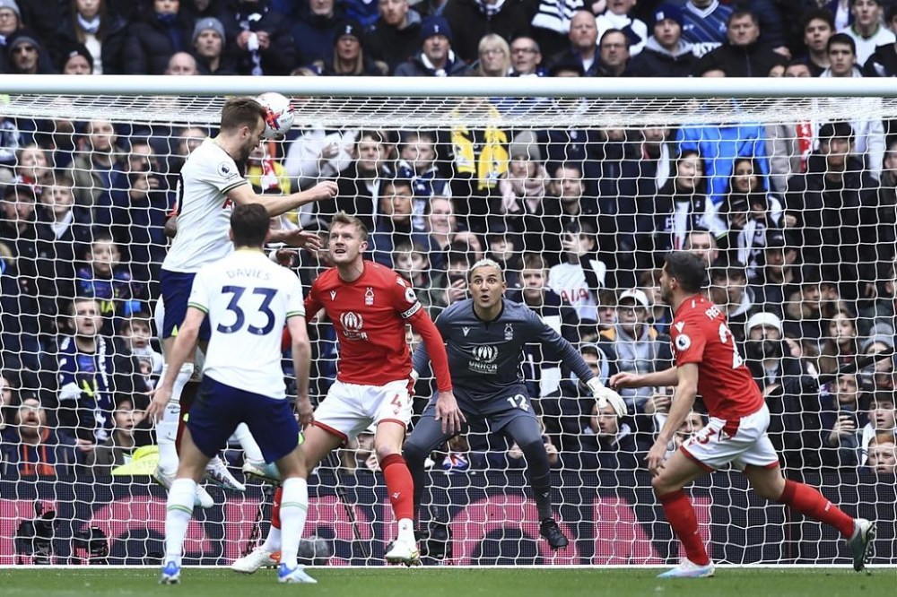 Tottenham's Harry Kane, top left, scores his side's opening goal during the English Premier League soccer match between Tottenham Hotspur and Nottingham Forest, at the Tottenham Hotspur stadium in London, Saturday, March 11, 2023. (AP Photo/Leila Coker)