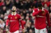 Manchester United's Bruno Fernandes, left, and Manchester United's Marcus Rashford react during the English Premier League soccer match between Manchester United and Southampton at Old Trafford stadium in Manchester, England, Sunday, March 12, 2023. (AP Photo/Jon Super)