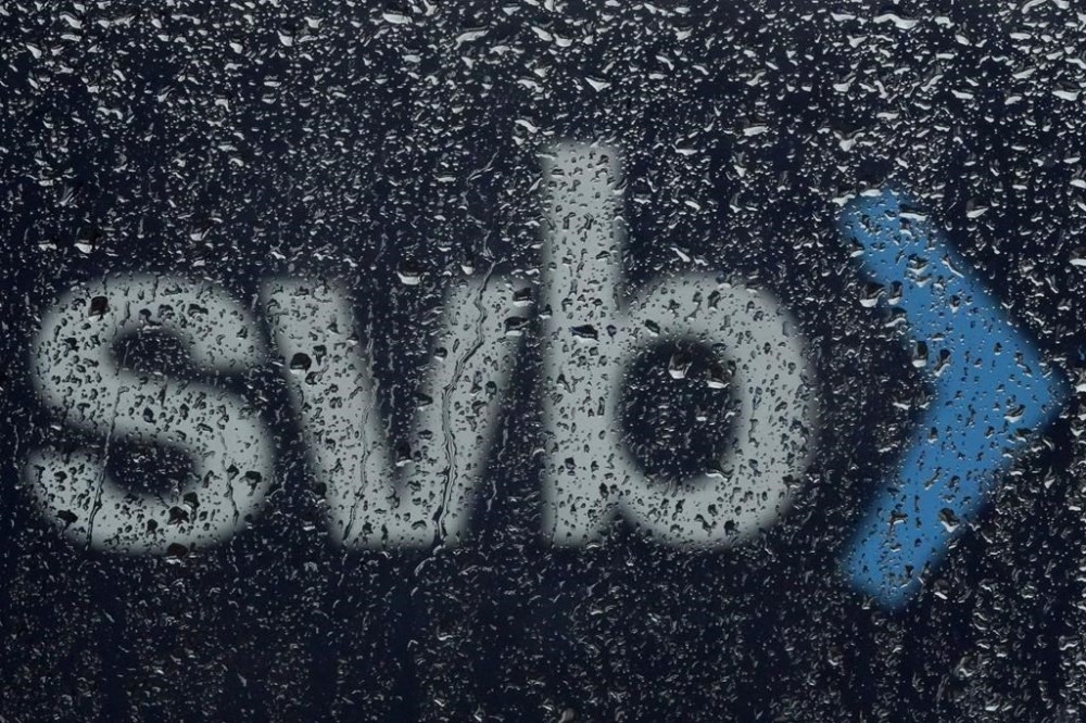 A sign to Silicon Valley Bank is seen through raindrops on a window in Santa Clara, Calif., Friday, March 10, 2023. The Federal Deposit Insurance Corporation is seizing the assets of Silicon Valley Bank, marking the largest bank failure since Washington Mutual during the height of the 2008 financial crisis. The FDIC ordered the closure of Silicon Valley Bank and immediately took position of all deposits at the bank Friday.(AP Photo/Jeff Chiu)