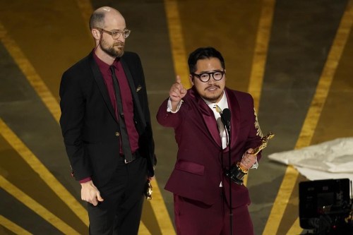 Daniel Scheinert, left, and Daniel Kwan accept the award for best original screenplay for 