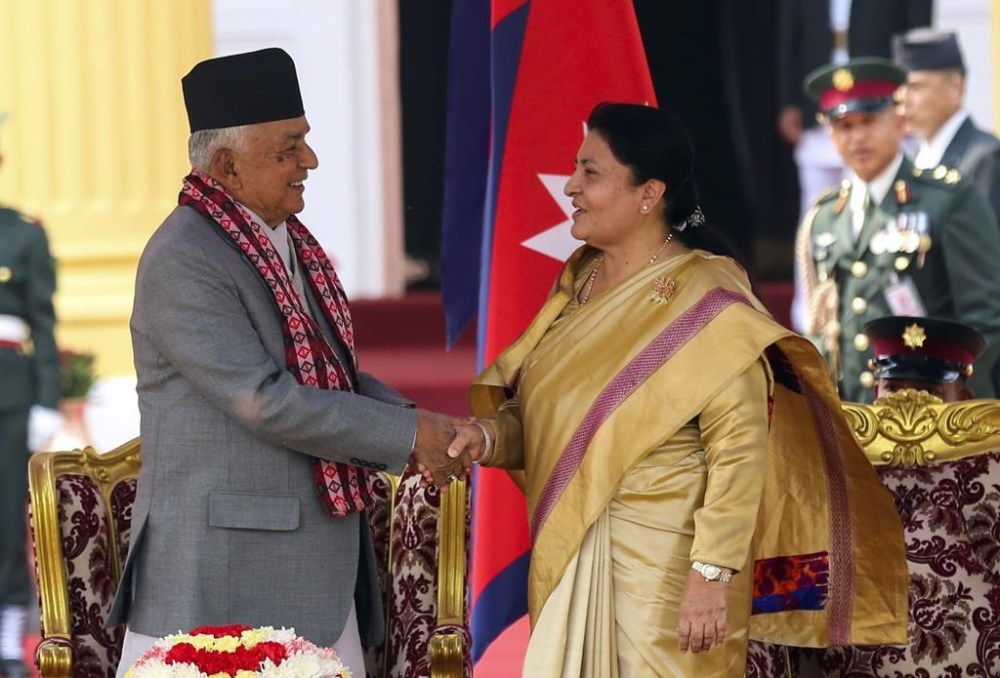 Outgoing President Bidhya Devi Bhandari, right, congratulates Nepal's newly elected president Ram Chandra Poudel, after he took the oath of office at the presidential building