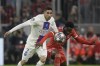 PSG's Achraf Hakimi, left, challenges for the ball with Bayern's Alphonso Davies during the Champions League round of 16 second leg soccer match between Bayern Munich and Paris Saint Germain at the Allianz Arena in Munich, Germany, Wednesday, March 8, 2023. (AP Photo/Andreas Schaad)