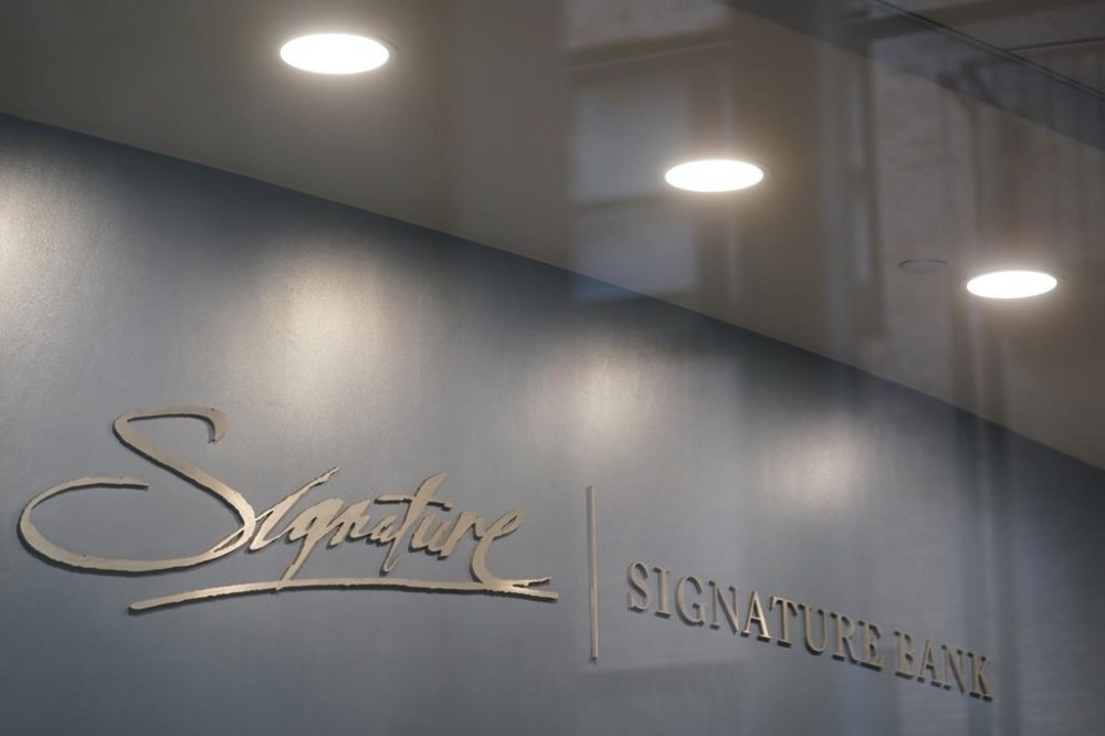 A sign is displayed at a branch of Signature Bank in New York, Monday, March 13, 2023. President Joe Biden is telling Americans that the nation's financial systems are sound. This comes after the swift and stunning collapse of two banks that prompted fears of a broader upheaval. (AP Photo/Seth Wenig)