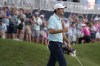 Scottie Scheffler celebrates after putting on the 18th green during the final round of The Players Championship golf tournament, Sunday, March 12, 2023, in Ponte Vedra Beach, Fla. (AP Photo/Charlie Neibergall)