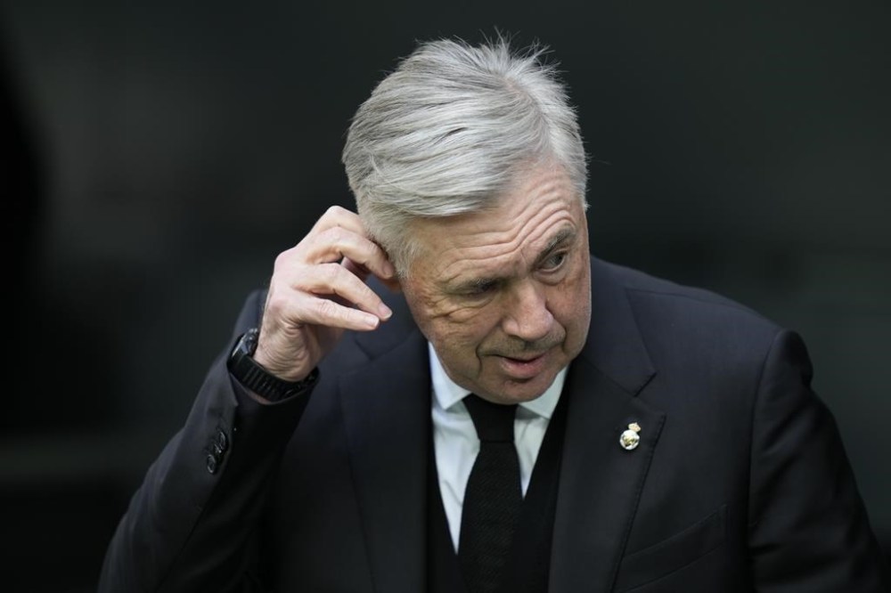 Real Madrid's head coach Carlo Ancelotti touches his ear during a Spanish La Liga soccer match between Real Madrid and Espanyol at the Santiago Bernabeu stadium in Madrid, Spain, Saturday, March 11, 2023. (AP Photo/Bernat Armangue)
