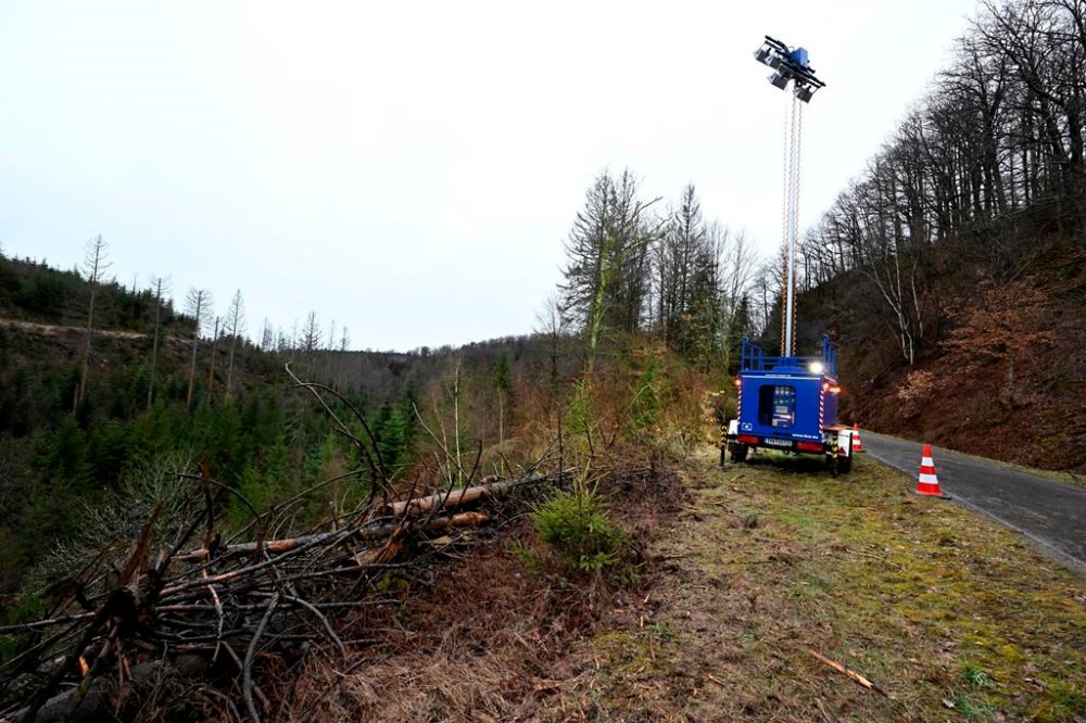 A spotlight from the Siegen Technical Relief Agency stands in a wooded area in Freudenberg, Germany, Monday, March 13, 2023 where the body of a 12-year-old girl was found the day before. The girl went missing on Saturday and the police launched a large-scale search operation, during which the body was discovered on Sunday. German police said Tuesday a 12-year-old girl, who was found dead earlier this week in the western German town of Freudenberg, was killed by two children. (Roberto Pfeil/dpa via AP)