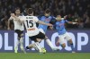 Atalanta's Marten de Roon, left, and Napoli's Khvicha Kvaratskhelia battle for the ball during the Serie A soccer match between Napoli and Atalanta at Diego Armando Maradona stadium in Naples, Italy, Saturday March 11, 2023. (Alessandro Garofalo/LaPresse via AP)