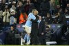 Manchester City's head coach Pep Guardiola, right, embraces Manchester City's Erling Haaland during the Champions League round of 16 second leg soccer match between Manchester City and RB Leipzig at the Etihad stadium in Manchester, England, Tuesday, March 14, 2023. (AP Photo/Dave Thompson)