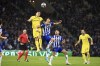 Inter Milan's Lautaro Martinez, center left, jumps for the ball with Porto's Marko Grujic during the Champions League round of 16, 2nd leg, soccer match between FC Porto and Inter Milan at the Dragao stadium in Porto, Portugal, Tuesday, March 14, 2023. (AP Photo/Luis Vieira)