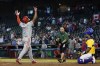 Canada's Otto Lopez, left, celebrates after hitting a three-run home run against Colombia during the ninth inning of a World Baseball Classic game in Phoenix, Tuesday, March 14, 2023. (AP Photo/Godofredo A. Vásquez)