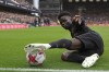 Arsenal's Bukayo Saka stretches to keep the ball in play during the English Premier League soccer match between Fulham and Arsenal at Craven Cottage stadium in London, Sunday, March 12, 2023. (AP Photo/Ian Walton)