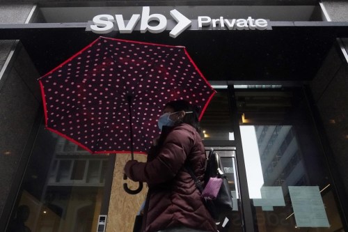 Members of Canada's technology sector say they're worried the collapse of the Silicon Valley Bank will have a chilling effect on investments in their sector. A pedestrian carries an umbrella while walking past a Silicon Valley Bank Private branch in San Francisco, Tuesday, March 14, 2023. (AP Photo/Jeff Chiu)