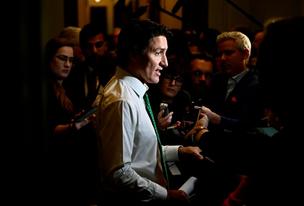 Prime Minister Justin Trudeau speaks to reporters before heading into a meeting of the Liberal caucus, on Parliament Hill in Ottawa, on Wednesday, March 8, 2023. THE CANADIAN PRESS/Justin Tang