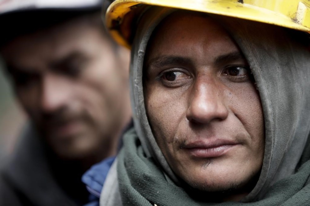Miners wait for news of fellow workers after an explosion at a coal mine that according to authorities killed at least 11 people in Sutatausa, Cundinamarca department, Colombia, Wednesday, March 15, 2023. (AP Photo/Ivan Valencia)