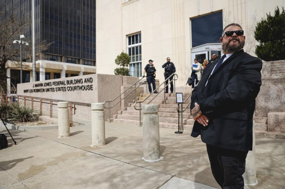 A security guard keeps an eye outside the federal courthouse on Wednesday, March 15, 2023, in Amarillo, Texas, where a federal judge is expected to hear arguments in a lawsuit that takes aim at medication abortions. Pills are the the most common method for obtaining an abortion in the U.S. (AP Photo/David Erickson)