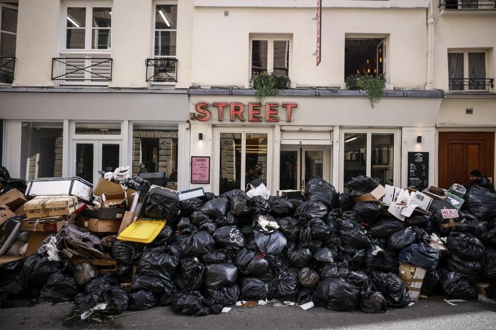 Uncollected garbage is piled up on a street in Paris, Wednesday, March 15, 2023 during an ongoing strike by sanitation workers. Opponents of French President Emmanuel Macron's pension plan are staging a new round of strikes and protests as a joint committee of senators and lower-house lawmakers examines the contested bill. (AP Photo/Thomas Padilla)