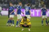 Dortmund's Mahmoud Dahoud sits on the ground disappointed after the German Bundesliga soccer match between FC Schalke 04 and Borussia Dortmund in Gelsenkirchen, Germany, Saturday, March 11, 2023. (AP Photo/Martin Meissner)