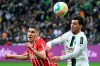 Gladbach's Joe Scally, right, and Freiburg's Roland Sallai, left, challenge for the ball during the German Bundesliga soccer match between Borussia Moenchengladbach and SC Freiburg in Moenchengladbach, Germany, Saturday, March 4, 2023. (Federico Gambarini/dpa via AP)
