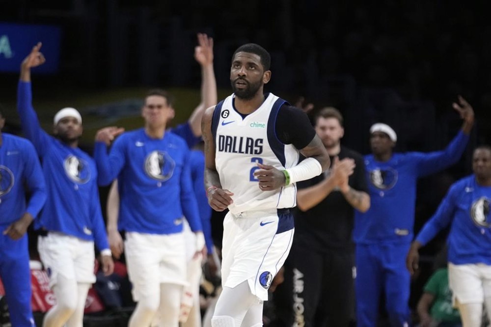 Dallas Mavericks guard Kyrie Irving (2) runs back after scoring during the second half of an NBA basketball game against the Los Angeles Lakers Friday, March 17, 2023, in Los Angeles. (AP Photo/Marcio Jose Sanchez)