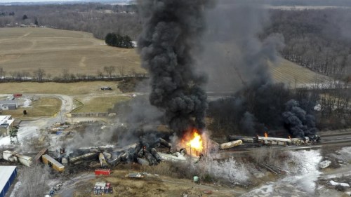 FILE - This photo taken with a drone shows portions of a Norfolk and Southern freight train that derailed Friday night in East Palestine, Ohio are still on fire at mid-day Saturday, Feb. 4, 2023. Soon after the train derailed and spilled toxic chemicals in Ohio last month, anonymous pro-Russian accounts started spreading misleading claims and anti-American propaganda about it on Twitter, using Elon Musk's new verification system to expand their reach while creating the illusion of credibility. (AP Photo/Gene J. Puskar, File)