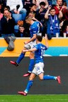 Hoffenheim's Andrej Kramaric, left, celebrates with team mates after scoring to 1-0 during the Bundesliga soccer match between TSG 1899 Hoffenheim and Hertha BSC at the PreZero Arena in Sinsheim, Germany, Saturday March 18, 2023. (Uwe Anspach/dpa via AP)