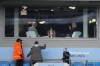 A fan takes photo of a British soccer broadcaster Gary Lineker, right, before the English FA Cup quarter final soccer match between Manchester City and Burnley at the Etihad stadium in Manchester, England, Saturday, March 18, 2023. (AP Photo/Jon Super)