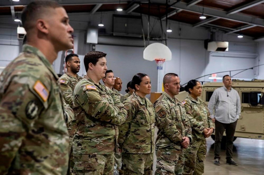 National Guard members listen to California Gov. Gavin Newsom speak at a press conference announcing a $30 million investment to expand the state's National Guard efforts in preventing drug-trafficking at a National Guard Armory in National City, Calif., on Sunday, March 19, 2023.(Adriana Heldiz/The San Diego Union-Tribune via AP, Pool)