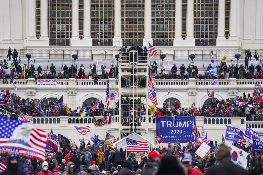 FILE - Insurrectionists loyal to President Donald Trump breach the U.S. Capitol in Washington, on Jan. 6, 2021. Four people associated with the Oath Keepers were convicted on Monday, March 20, 2023, of conspiracy and obstruction charges stemming from the attack on the U.S. Capitol in the latest trial involving members of the far-right antigovernment extremist group. (AP Photo/John Minchillo)