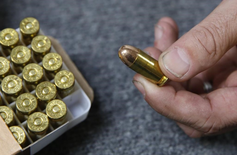 FILE - Chris Puehse, owner of Foothill Ammo, displays .45-caliber ammunition for sale at his store in Shingle Springs, Calif., on June 11, 2019. A federal judge on Monday, March 20, 2023, blocked key provisions of a California law that drastically restricts the sale of new handguns in the state, saying parts of the legislation violate the Second Amendment. (AP Photo/Rich Pedroncelli, File)
