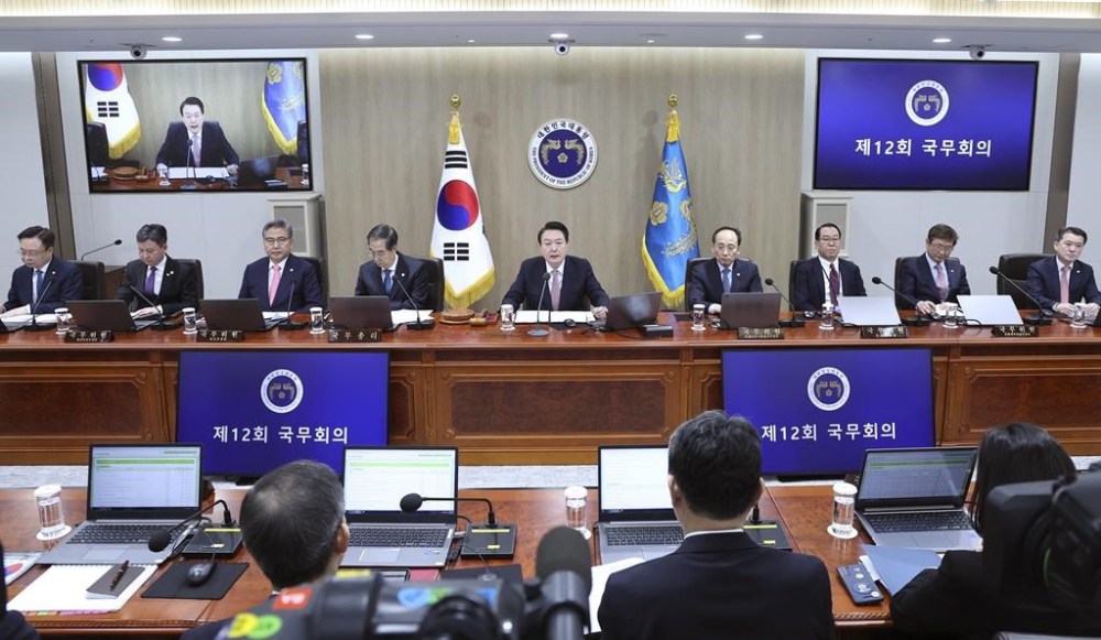 South Korean President Yoon Suk Yeol, top center, speaks during a Cabinet meeting at the president office in Seoul, South Korea, Tuesday, March 21, 2023. President Yoon said Tuesday his government will take steps to restore Japan’s preferential trade status as he's trying to push for his contentious bid to resolve fraught ties with Japan despite domestic opposition.(Lim Hun-jung/Yonhap via AP)