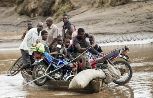 FILE - Men transport their salvaged belongings in Chiradzulu, southern Malawi, March 17, 2023. During a conference in the Ethiopian capital of Addis Ababa on Monday, March 20, 2023, leaders of African countries hit hard by climate change discussed finance options that would allow for the forgiveness of debt in exchange for investment in green energies. (AP Photo/Thoko Chikondi, File)
