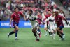 Vancouver Whitecaps' Sergio Cordova, centre, and FC Dallas' Nkosi Tafari, right, vie for the ball during the second half of an MLS soccer game in Vancouver, on Saturday, March 11, 2023. THE CANADIAN PRESS/Darryl Dyck