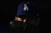 Los Angeles Dodgers starting pitcher Clayton Kershaw (22) looks over his glove as he warms up in the bullpen before a spring training baseball game against the Texas Rangers in Glendale, Ariz., Thursday, March 16, 2023. (AP Photo/Ashley Landis)
