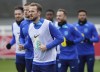 England's Harry Kane warms up during a training session ahead of Thursday's Euro 2024 qualifying soccer match against Italy, at St. George's Park, Burton-on-Trent, England, Tuesday March 21, 2023. (Nick Potts/PA via AP)