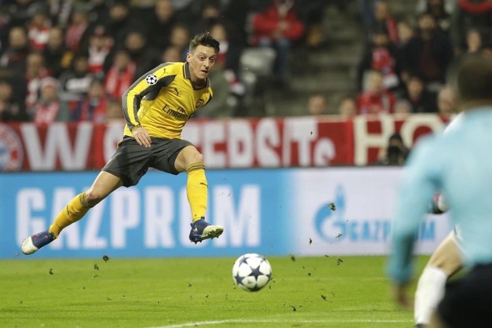 FILE - Arsenal's Mesut Ozil shoots on goal during the Champions League round of 16 first leg soccer match between FC Bayern Munich and Arsenal, in Munich, Germany, Wednesday, Feb. 15, 2017. Former Germany midfielder Mesut Özil, who won the World Cup in 2014, retired from soccer Wednesday, March 22, 2023, at the age of 34. (AP Photo/Matthias Schrader, File)