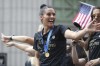 FILE - United States defender Ali Krieger waves to fans on a float while being honored with a ticker tape parade along the Canyon of Heroes, Wednesday, July 10, 2019, in New York. The U.S. national team beat the Netherlands 2-0 to capture a record fourth Women's World Cup title. Ali Krieger has decided to retire at the end of this season after a professional soccer career that has stretched some 16 years. Krieger announced her impending retirement on Thursday, March 23, 2023. (AP Photo/Steve Luciano, File)