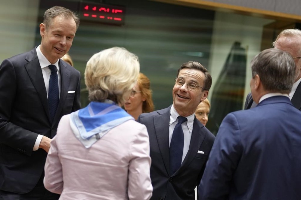 President of Business Europe Fredrik Persson, left, and Sweden's Prime Minister Ulf Kristersson, center, speak with European Commission President Ursula von der Leyen, second left, during a tripartite social summit ahead of an EU summit at the European Council building in Brussels, Wednesday, March 22, 2023. European Union leaders meet Thursday for a two-day summit to discuss the latest developments in Ukraine, the economy, energy and other topics including migration. (AP Photo/Virginia Mayo)