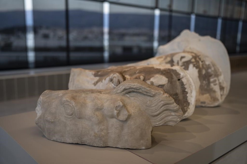 The newly placed fragment of the horse chariot of Selene, first of four, is on display at the Acropolis Museum during a ceremony for the repatriation of three sculpture fragments, in Athens, on Friday, March 24, 2023. Greece received three fragments from the ancient Parthenon temple that had been kept at Vatican museums for two centuries. Culture Ministry officials said the act provided a boost for its campaign for the return of the Parthenon Marbles from the British Museum in London. (AP Photo/Petros Giannakouris)