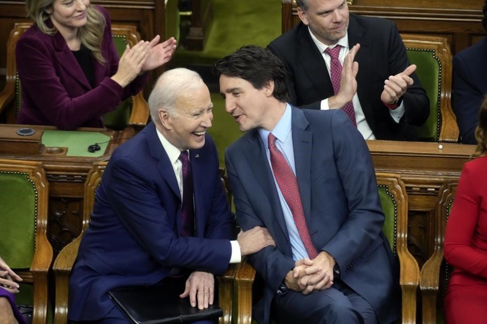 Canadian Prime Minister Justin Trudeau talks with President Joe Biden before Biden speaks to the Canadian Parliament, Friday, March 24, 2023, in Ottawa, Canada. (AP Photo/Andrew Harnik, Pool)