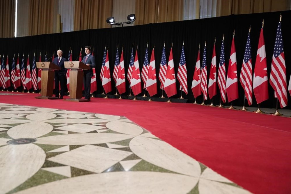 President Joe Biden listens as Canadian Prime Minister Justin Trudeau speaks during a news conference Friday, March 24, 2023, in Ottawa, Canada. (AP Photo/Andrew Harnik)