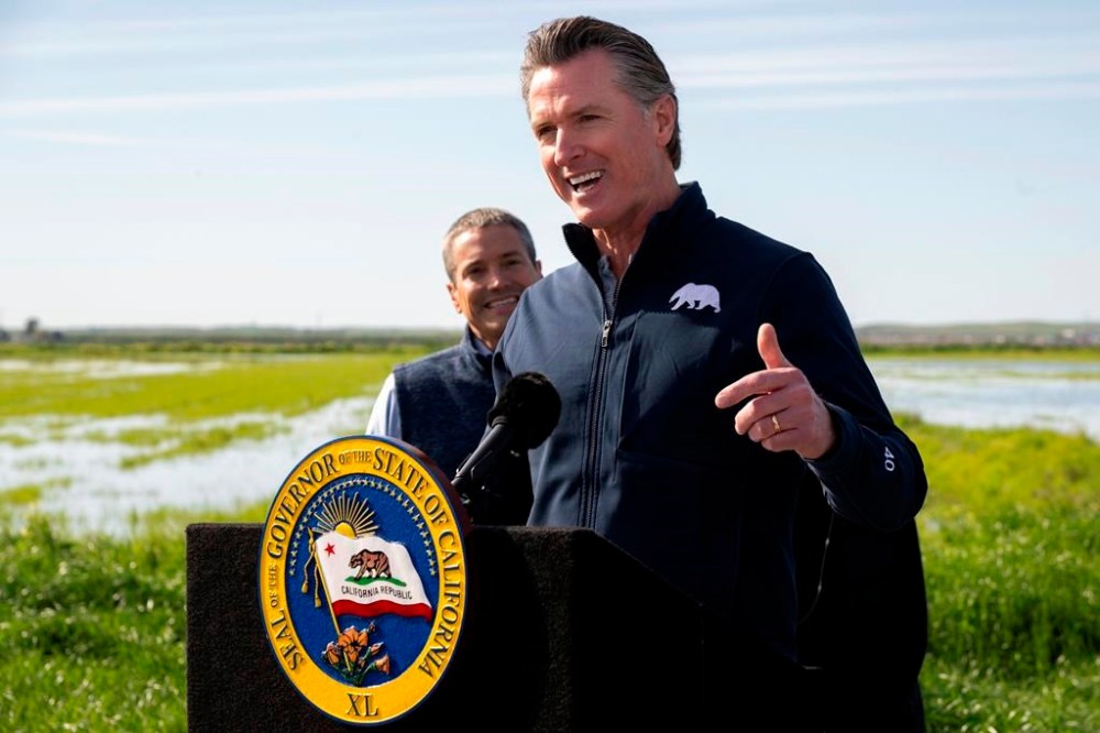 California Gov. Gavin Newsom talks during a news conference from a farm in Dunnigan, Calif., Friday, March 24, 2023. Newsom announced an end to some drought restrictions and calls for water conservation, following a series of winter storms have dramatically improved the state's water supply outlook. (Paul Kitagaki Jr./The Sacramento Bee via AP)