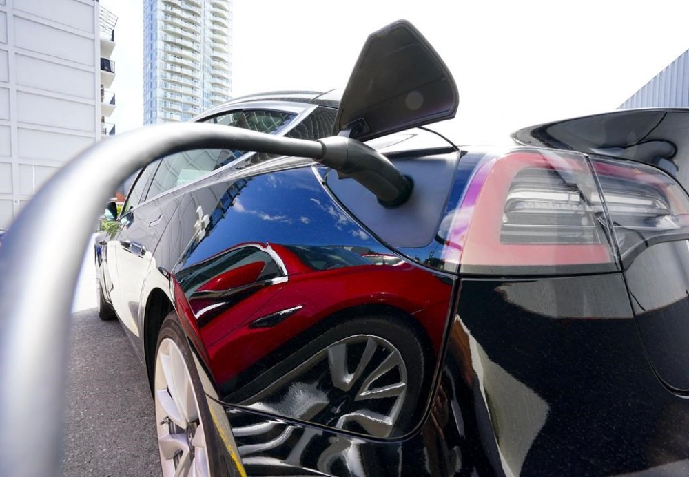 An electric vehicle is charged in Ottawa on Wednesday, July 13, 2022. Ottawa is expected to make big investments in clean energy and technology in the upcoming budget as it tries to keep competitive in the transition toward a greener economy. THE CANADIAN PRESS/Sean Kilpatrick