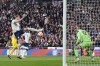 Englands' Harry Kane, left, makes an attempt to score past Ukraine's goalkeeper Anatoliy Trubin during the Euro 2024 group C qualifying soccer match between England and Ukraine at Wembley Stadium in London, Sunday, March 26, 2023. (AP Photo/Alastair Grant)