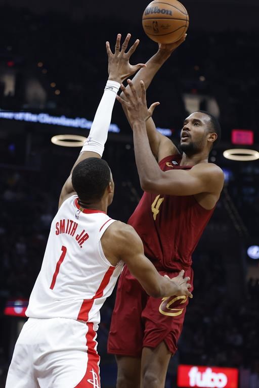 Cleveland Cavaliers forward Evan Mobley (4) shoots against Houston Rockets forward Jabari Smith Jr. (1) during the first half of an NBA basketball game, Sunday, March 26, 2023, in Cleveland. (AP Photo/Ron Schwane)